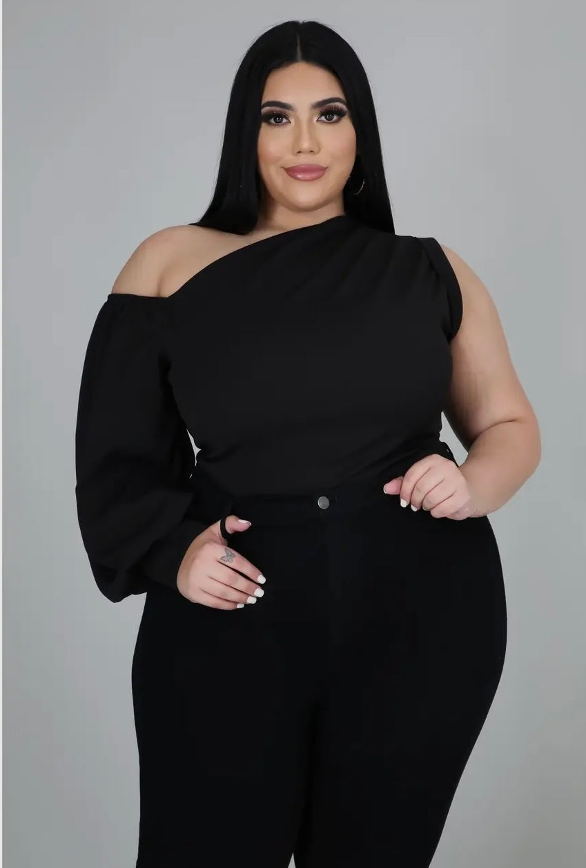 Plus size woman wearing black one-shoulder puff sleeve top from Adrienne Rebecca Boutique styled for evening wear
