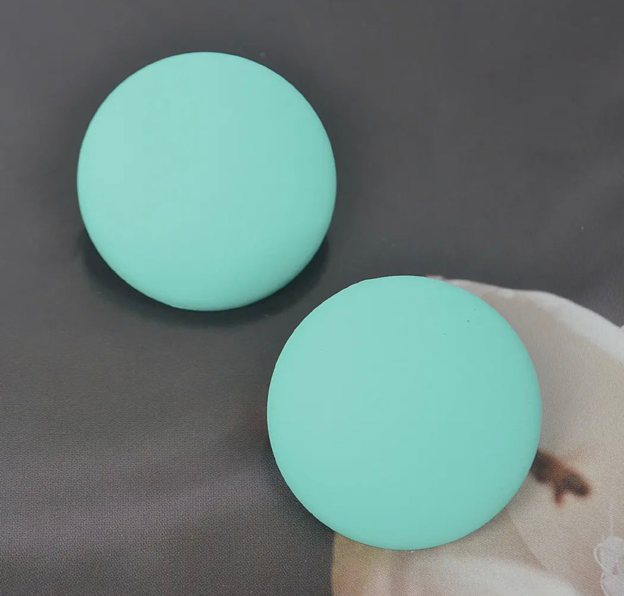 Set of matte stud earrings in black, yellow, and mint displayed from Adrienne Rebecca Boutique