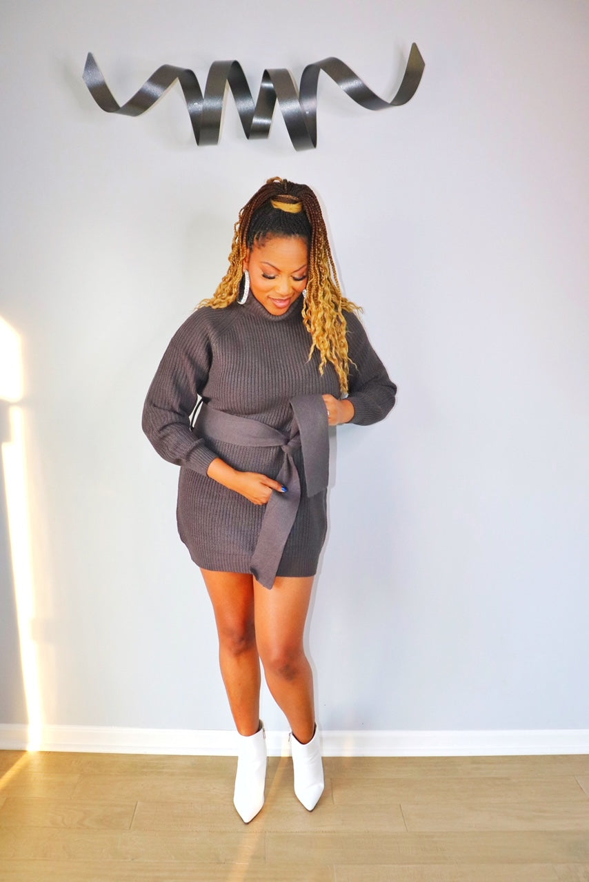 Woman wearing grey long sleeve turtleneck bodycon sweater dress from Adrienne Rebecca Boutique