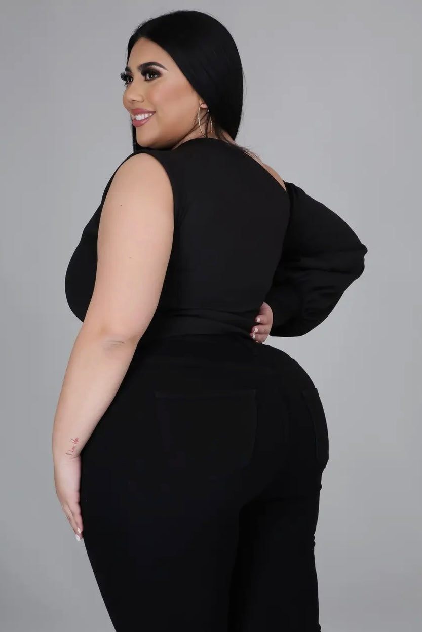 Plus size woman wearing black one-shoulder puff sleeve top from Adrienne Rebecca Boutique styled for evening wear