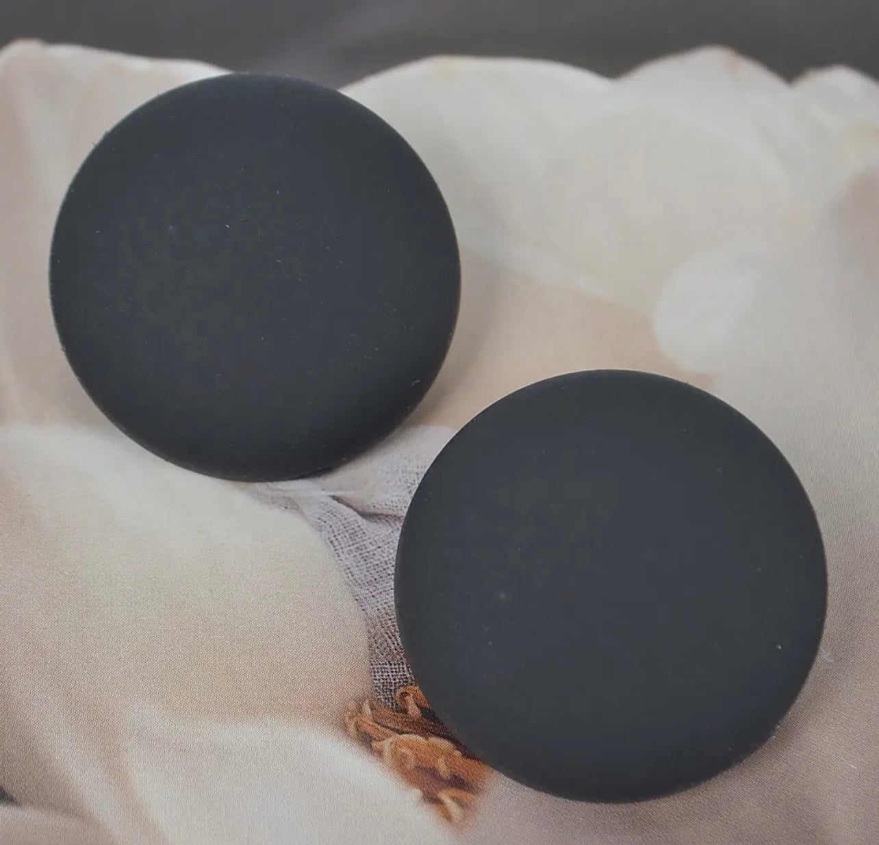 Set of matte stud earrings in black, yellow, and mint displayed from Adrienne Rebecca Boutique