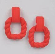 Poppy red twist hoop earrings from Adrienne Rebecca Boutique displayed on white background