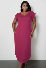 Plus size woman in a magenta short-sleeve maxi dress with pockets, casual and elegant everyday wear from Adrienne Rebecca Boutique.