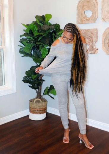 woman wearing a heather grey cold shoulder jogger set from Adrienne Rebecca Boutique