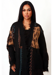Close-up of leopard distressed cardigan featuring thick knit fabric, mixed animal print panels, and ultra-soft texture.