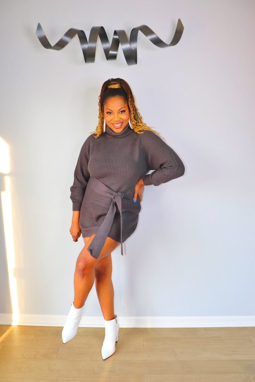 Woman wearing grey long sleeve turtleneck bodycon sweater dress from Adrienne Rebecca Boutique